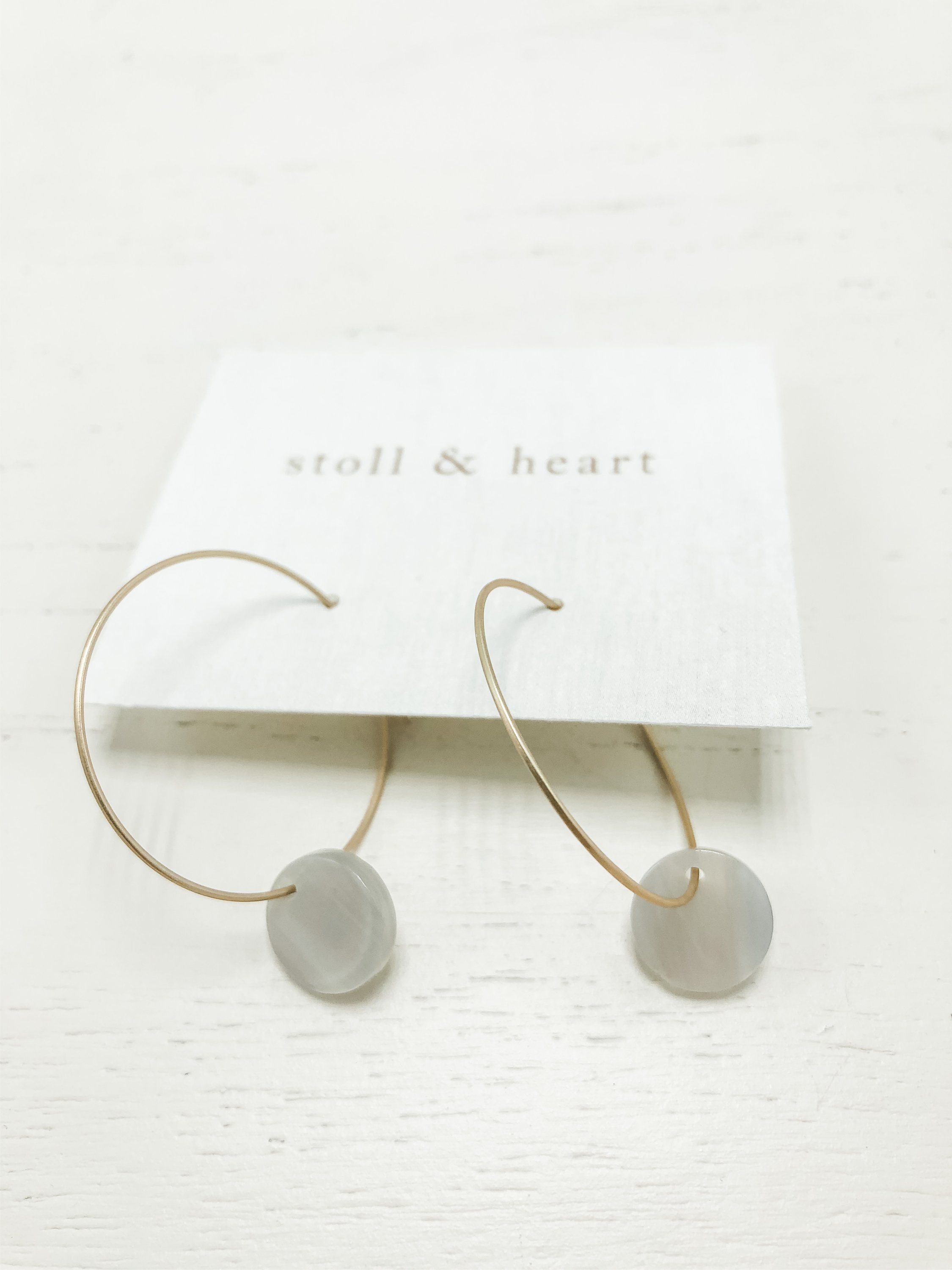 Marley Light Grey Rounds earrings featuring brass hoops with light grey resin details, elegantly designed for stylish wear.