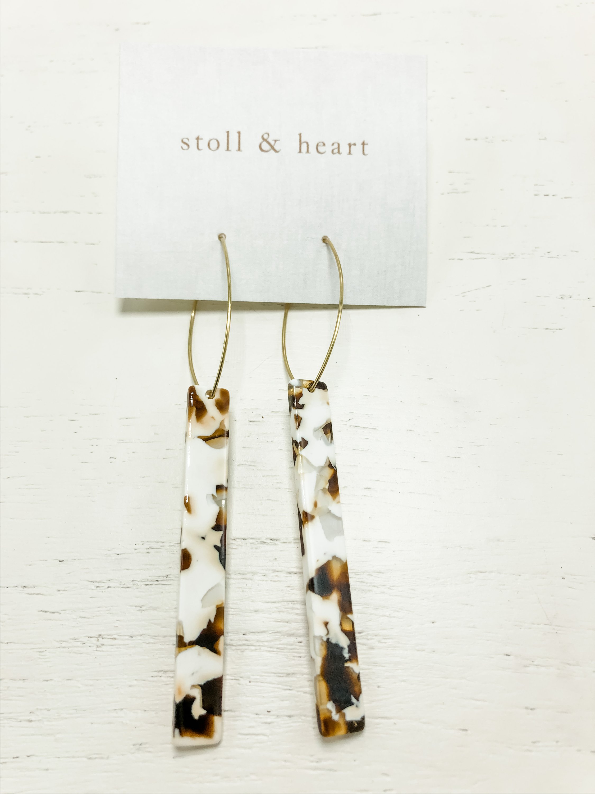 The Melissa Cream Tortoise Tall earrings featuring brass hoops and tortoise shell resin detail, elegantly displayed.