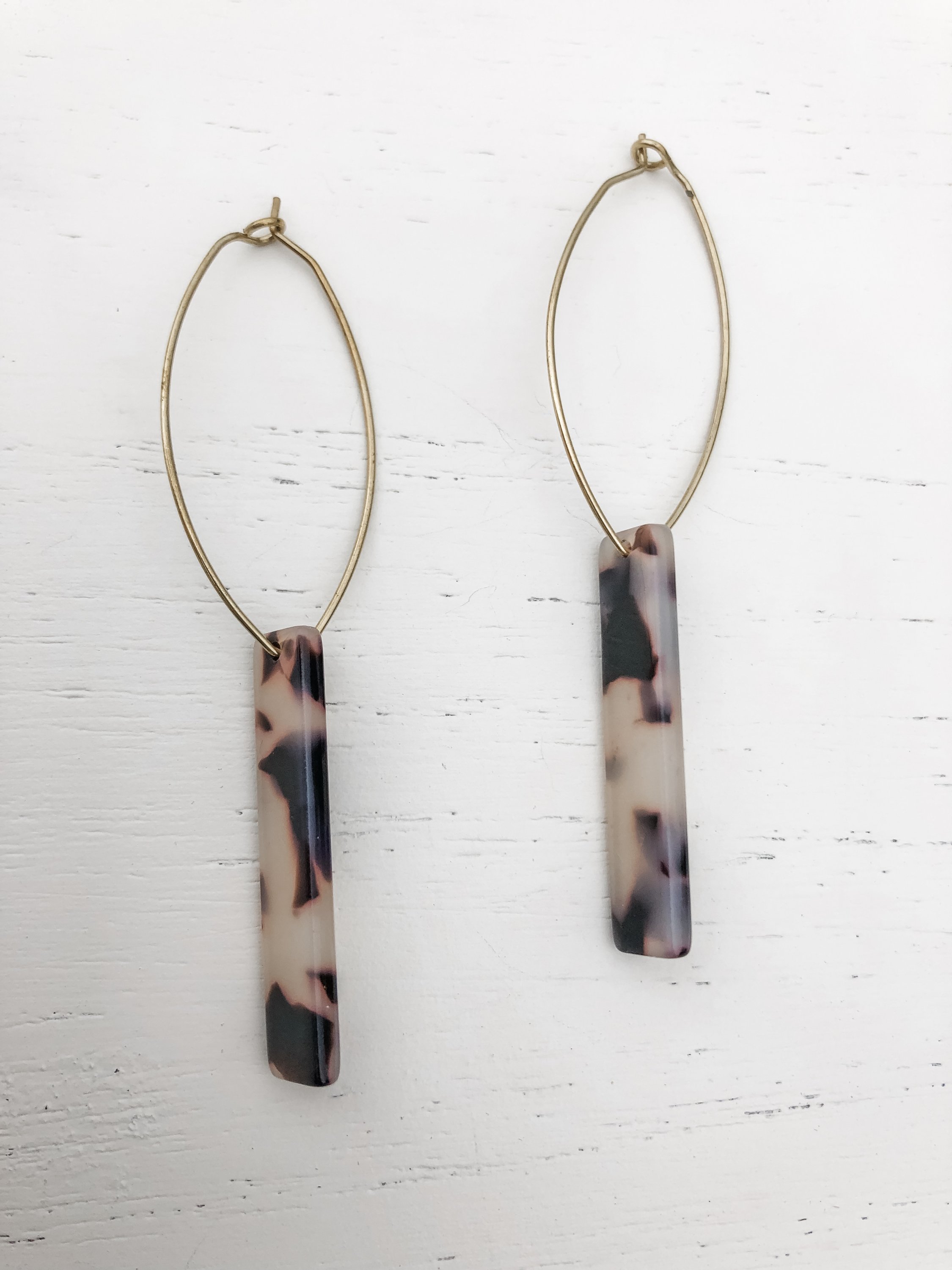 Melissa Shortie Grey Tortoise earrings featuring brass hoops and grey tortoise shell resin detail, elegantly designed for stylish wear.