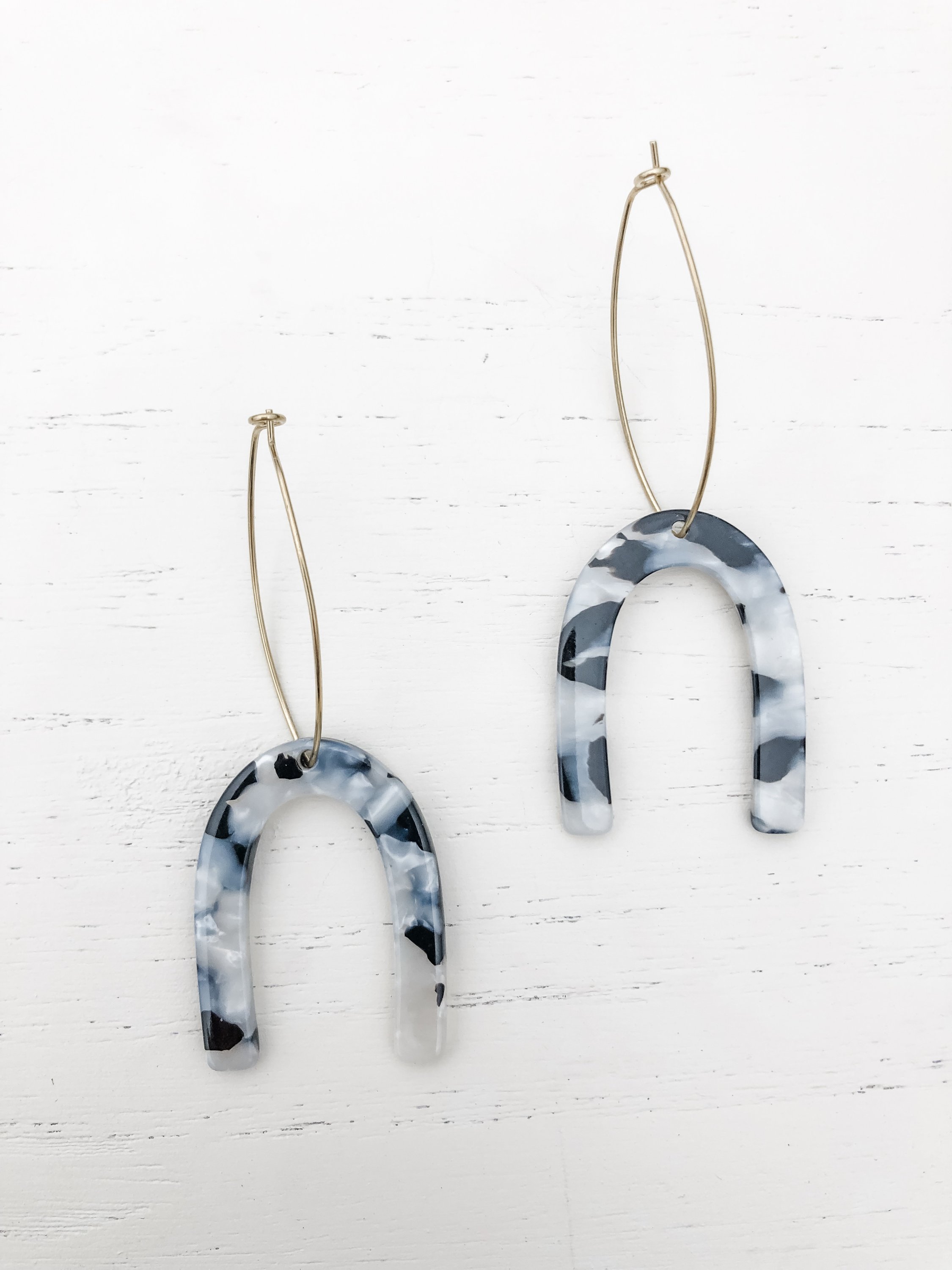 Miriam Black and White Tortoise earrings featuring brass hoops and tortoise shell resin detail, elegantly displayed.