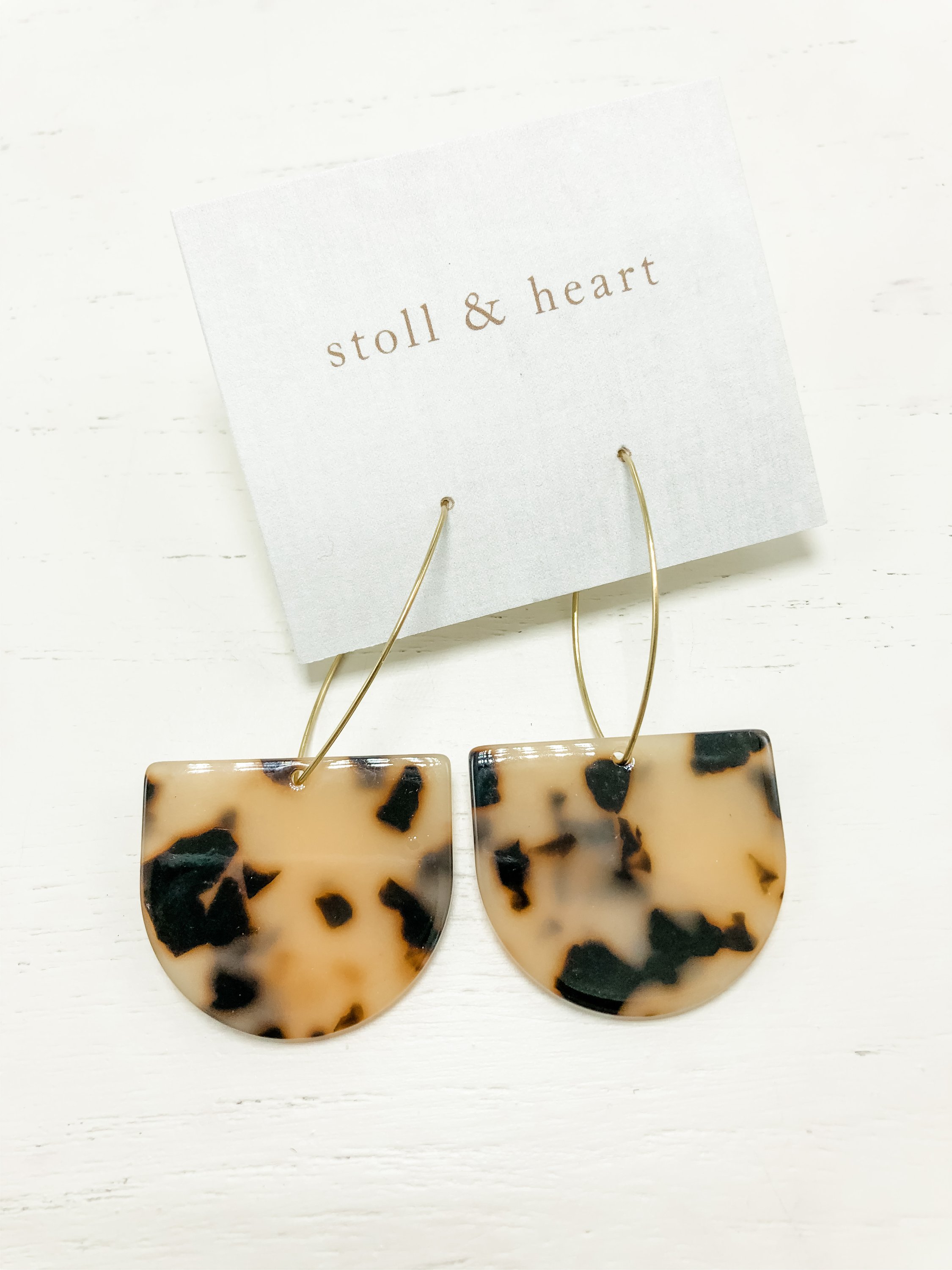 Stylish brass hoop earrings with light tortoise shell resin detail, measuring 2-7/8 inches in length.