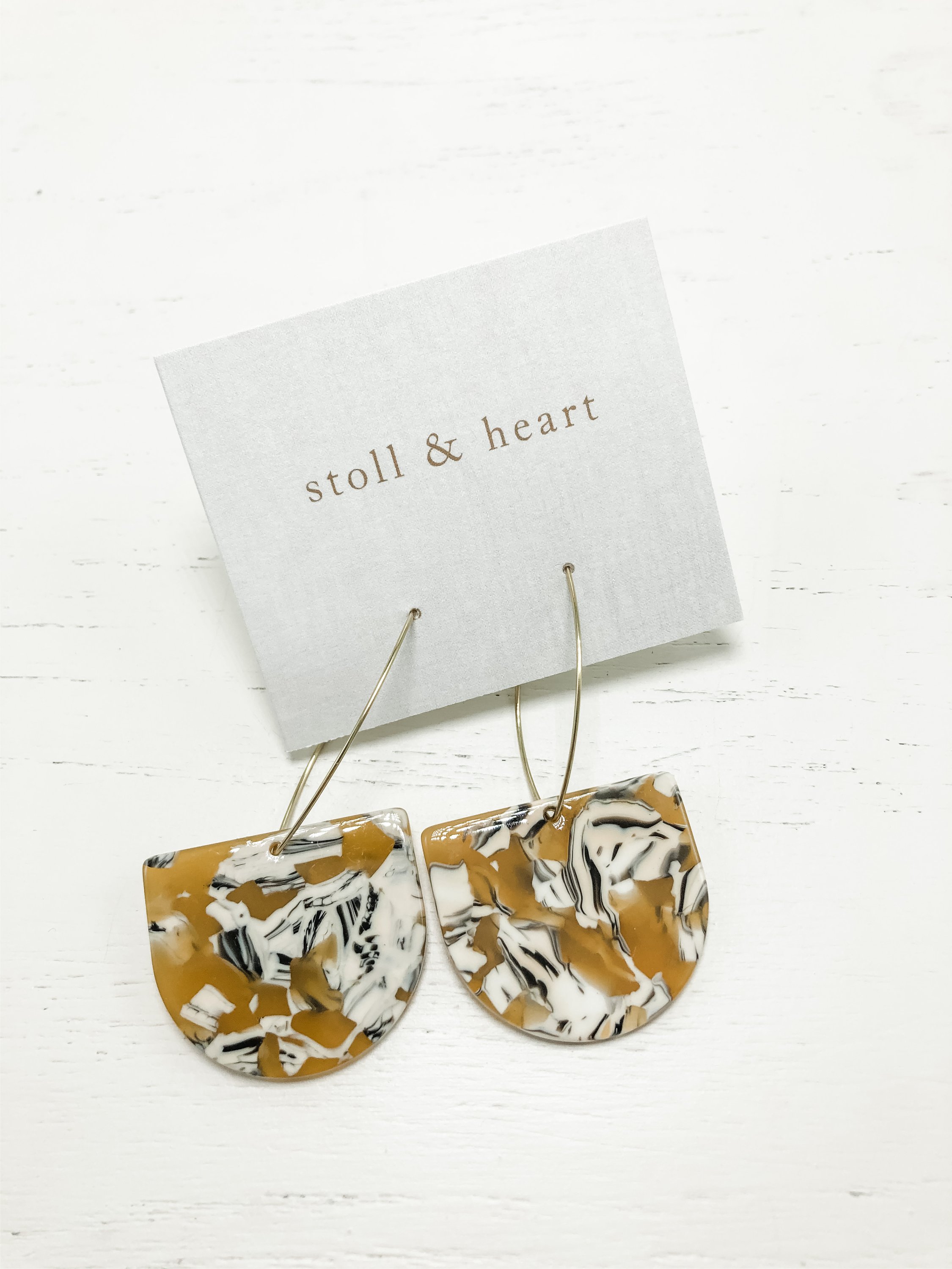 Stylish brass hoop earrings with mustard, beige, and black tortoise shell resin detail, measuring 2-7/8 inches long.