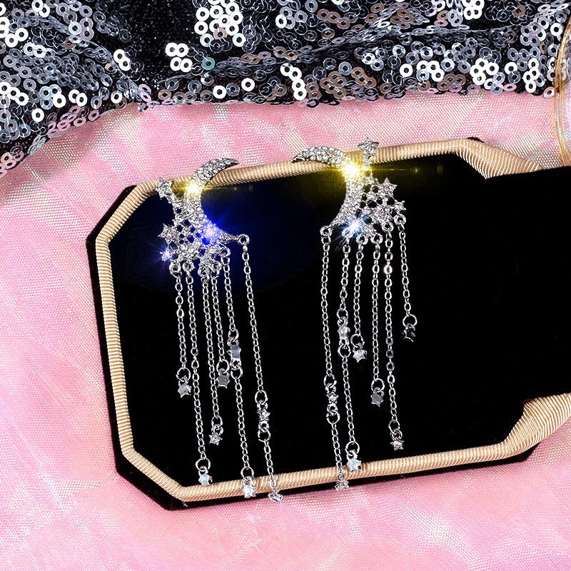 Elegant Moon and Star Tassel Earrings featuring rhinestones and alloy, showcasing a celestial design.