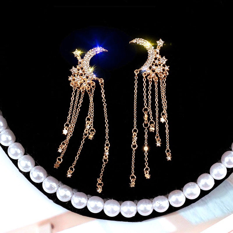 Elegant Moon and Star Tassel Earrings featuring rhinestones and alloy, showcasing a celestial design.