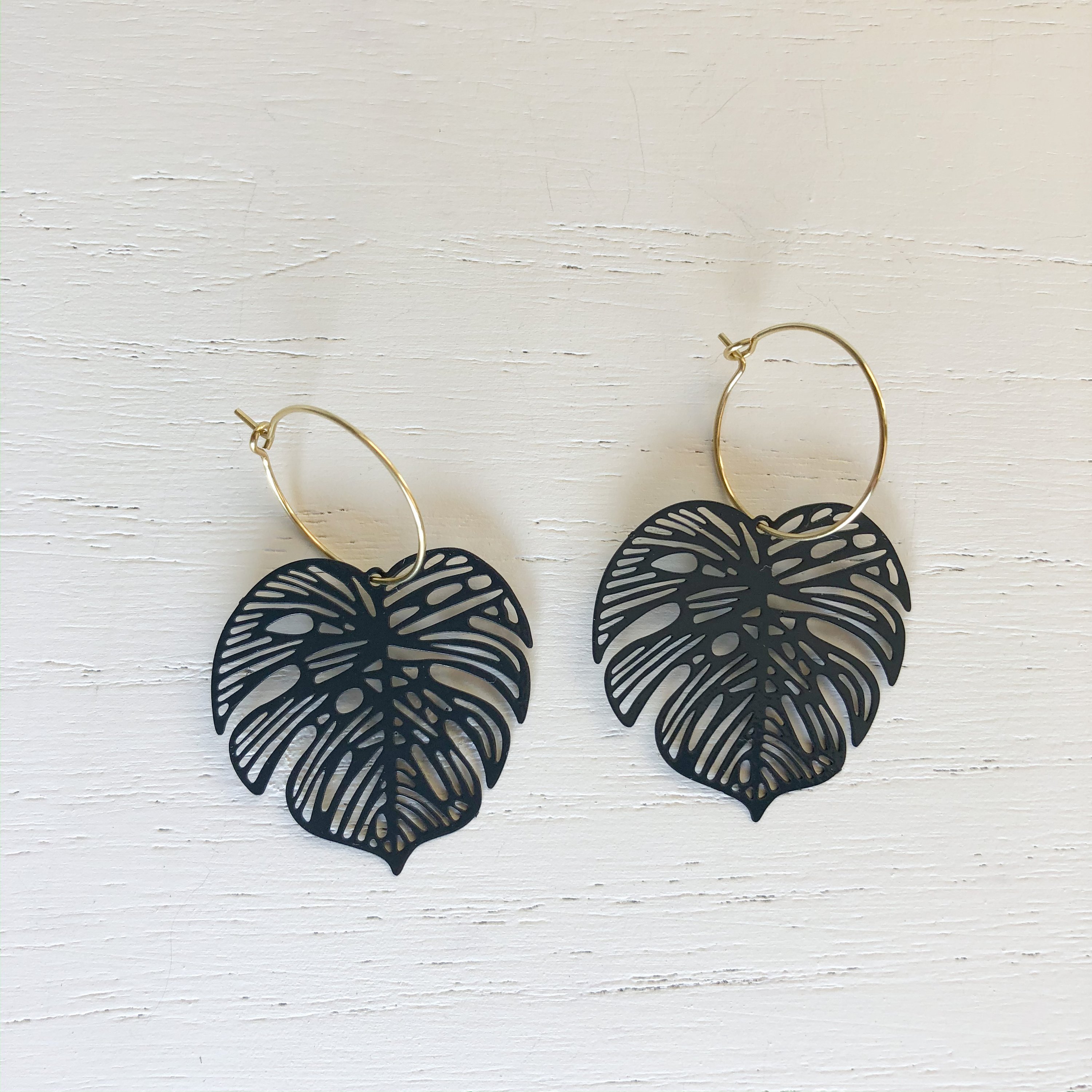 The Monstera - Black Brass earrings featuring elegant brass hoops with dark green detailing, measuring approximately 2 inches in length.