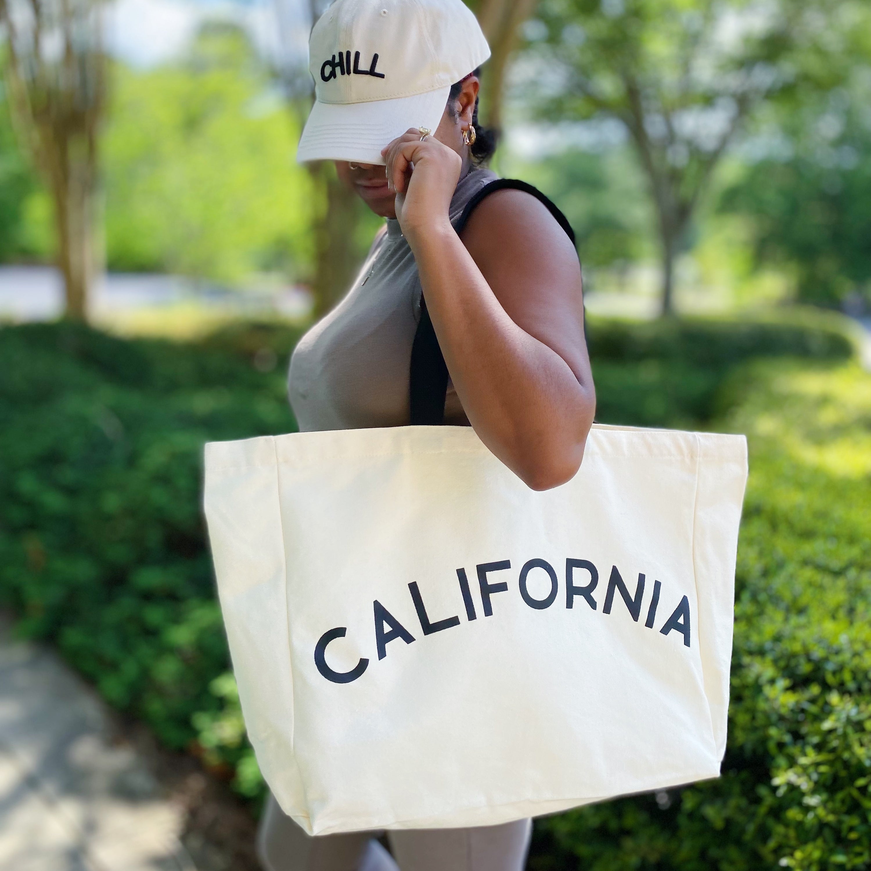 The State On My Mind Canvas Tote featuring a stylish state name print, spacious interior, and eco-friendly design.