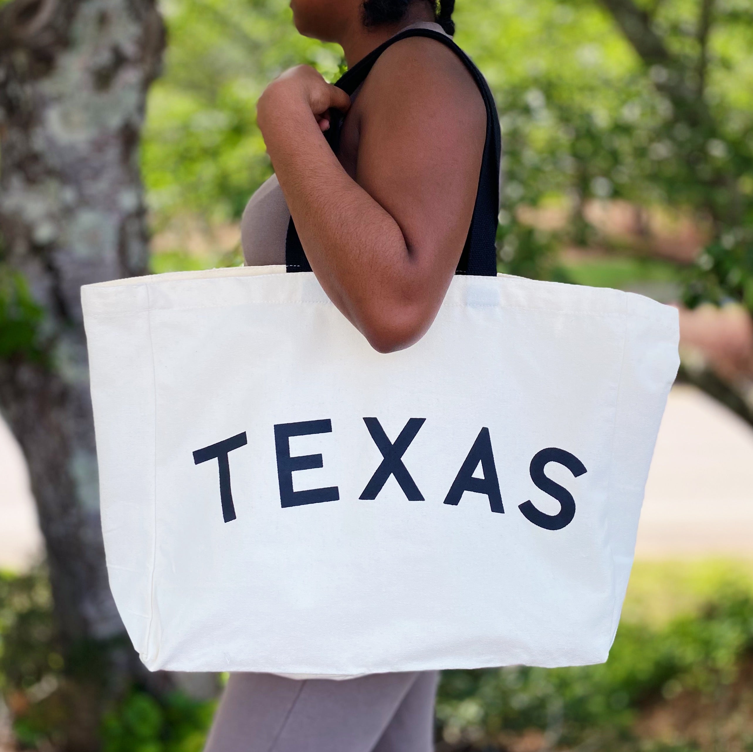 The State On My Mind Canvas Tote featuring a stylish state name print, spacious interior, and eco-friendly design.