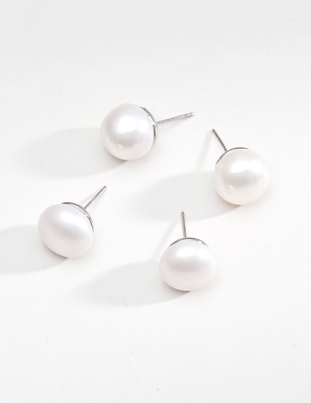 Elegant Pure Silver Pearl Stud Earrings featuring natural pearls and 925 silver setting in vintage gold and platinum finishes.