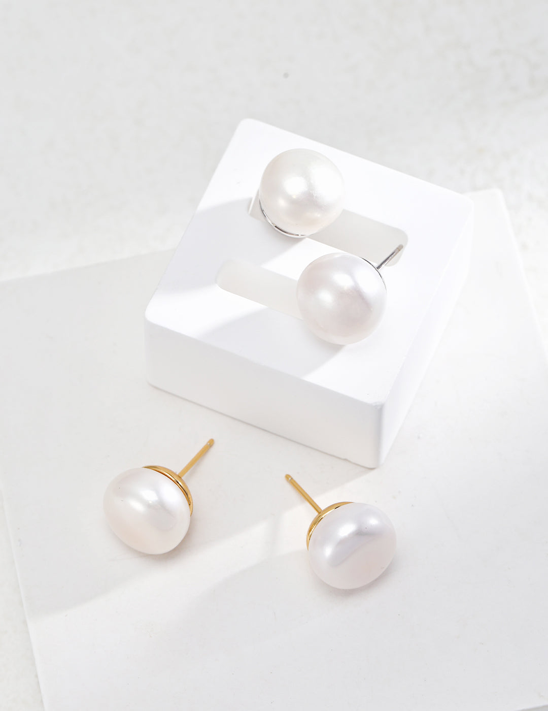 Elegant Pure Silver Pearl Stud Earrings featuring natural pearls and 925 silver setting in vintage gold and platinum finishes.