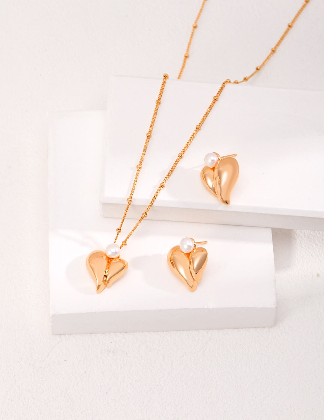 Three Dimensional Heart Pearl Necklace featuring freshwater pearls and gold vermeil pendant, elegantly displayed on a soft background.