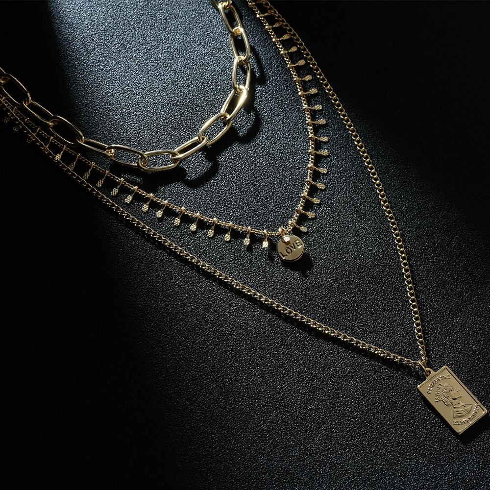 Three layer necklace featuring a rectangle pendant, elegantly designed with a 14k gold plated finish.