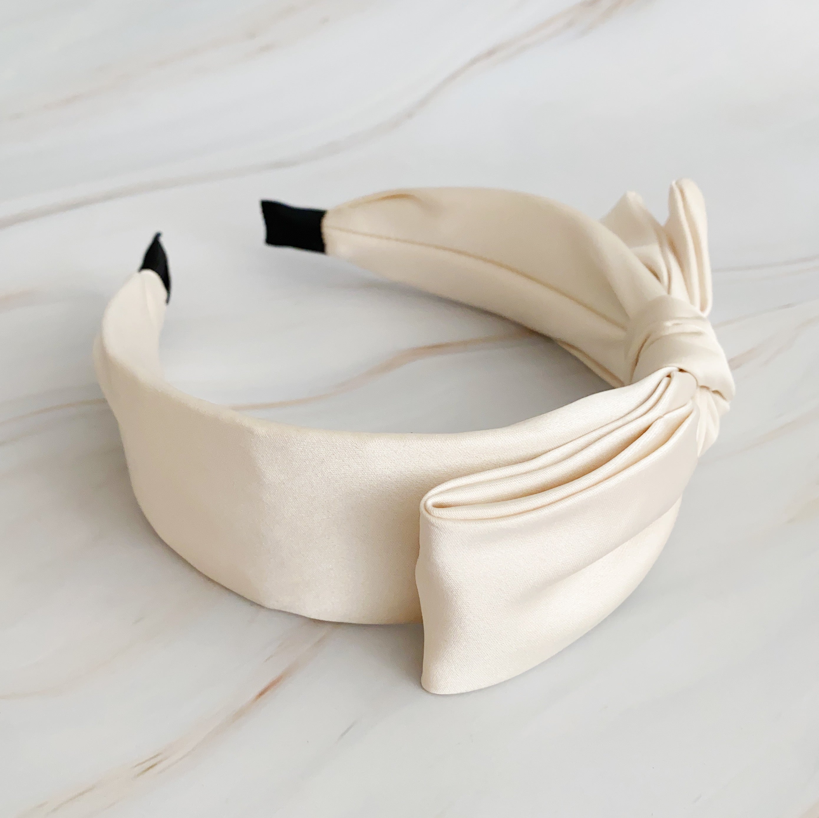 Elegant Tied Satin Side Bow Headband in luxurious satin fabric with a chic side bow design.