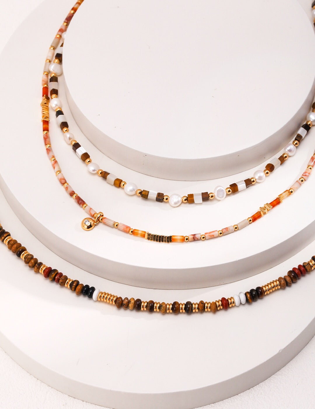 A beautiful handmade Tiger Eye Gemstone Beads Necklace featuring various gemstones and 18ct gold vermeil accents, elegantly displayed.