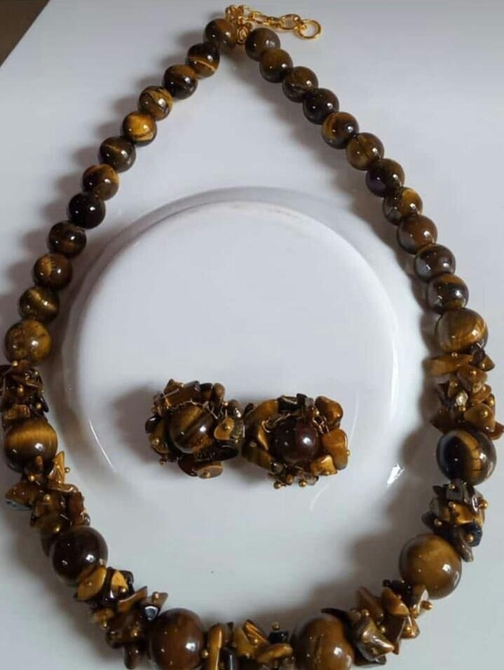 A beautiful Tiger Eye Gemstone Necklace and Earrings set showcasing natural golden-brown stones with a shimmering finish.