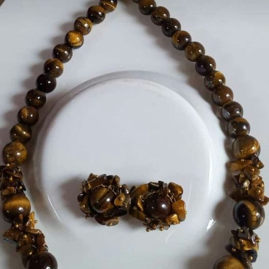 A beautiful Tiger Eye Gemstone Necklace and Earrings set showcasing natural golden-brown stones with a shimmering finish.