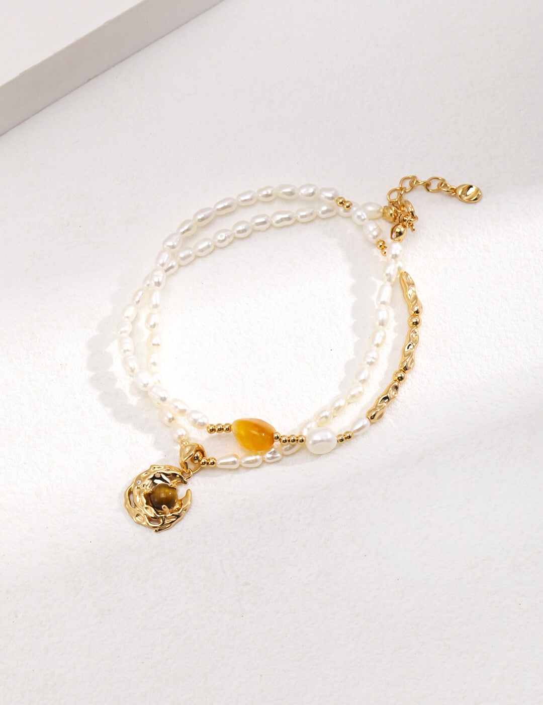 A stunning Tiger Eye Gemstone Pearl Necklace featuring natural tiger eye stones, pearls, and gold vermeil plating, elegantly displayed on a soft background.