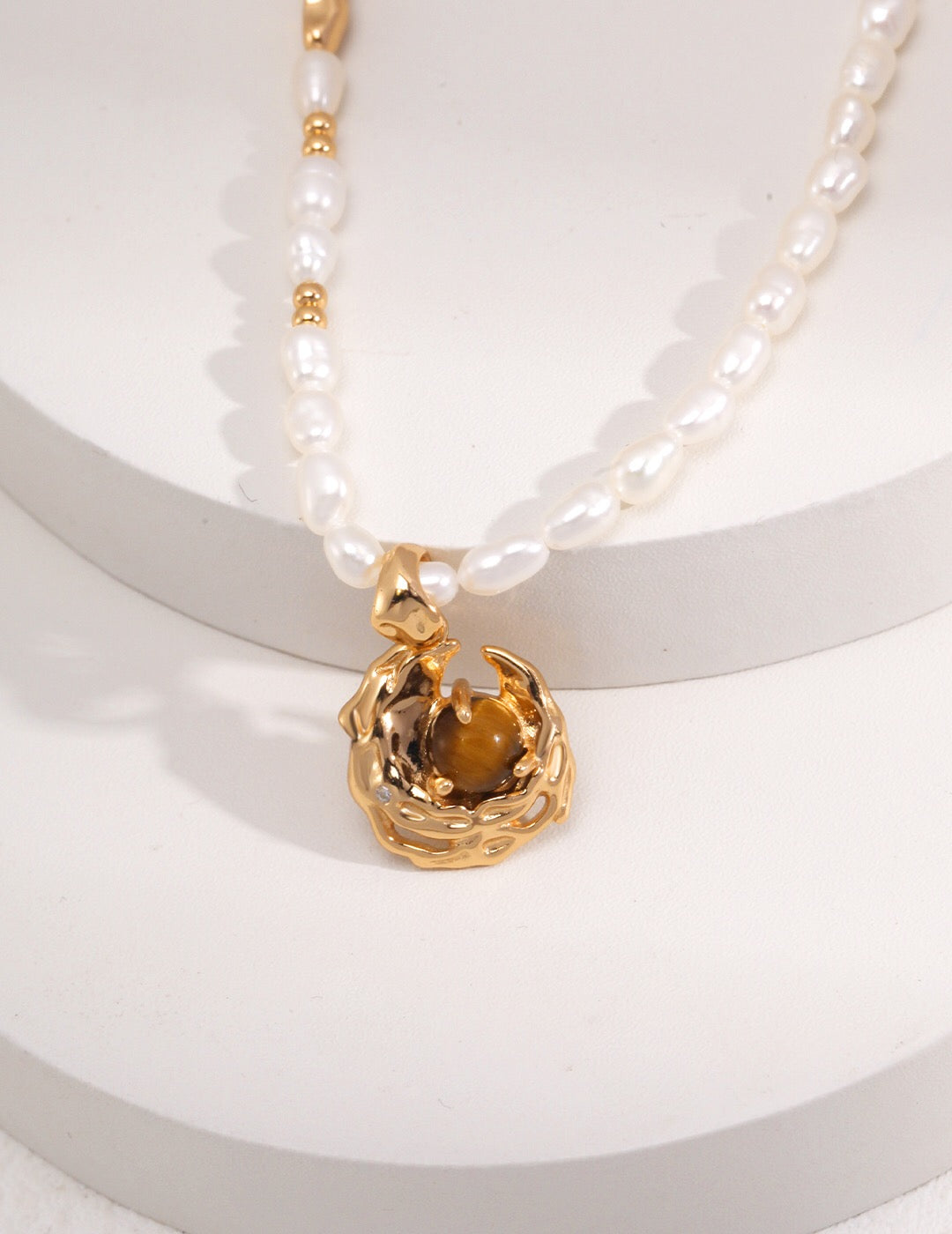 A stunning Tiger Eye Gemstone Pearl Necklace featuring natural tiger eye stones, pearls, and gold vermeil plating, elegantly displayed on a soft background.