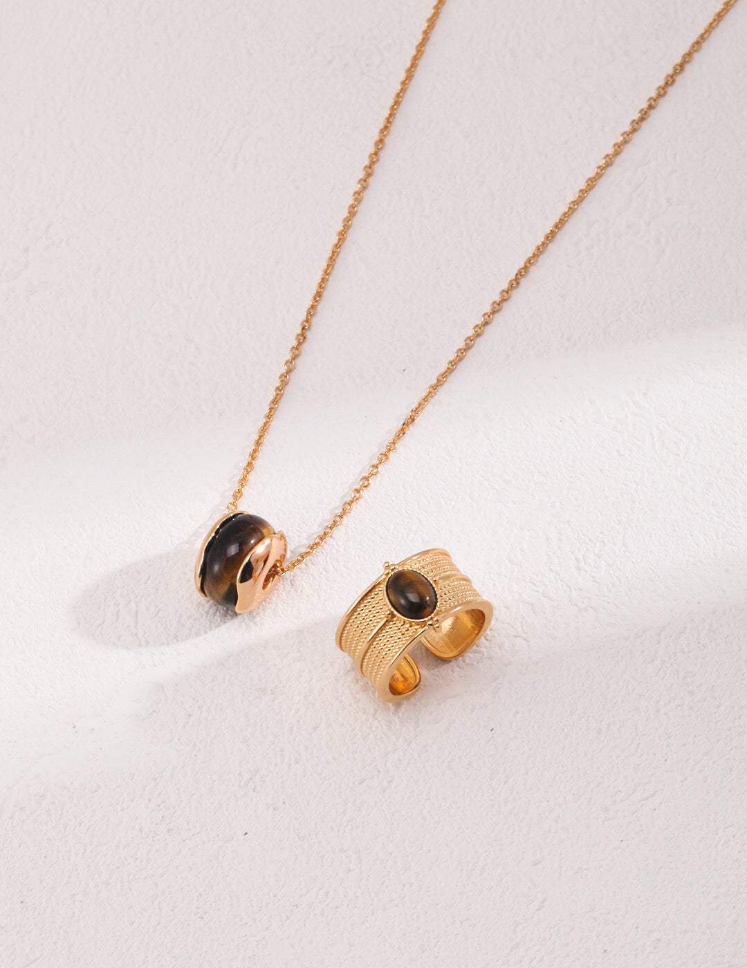 A beautiful handmade Tiger Eye Stone Necklace featuring a heart pendant, gold vermeil accents, and a delicate chain.