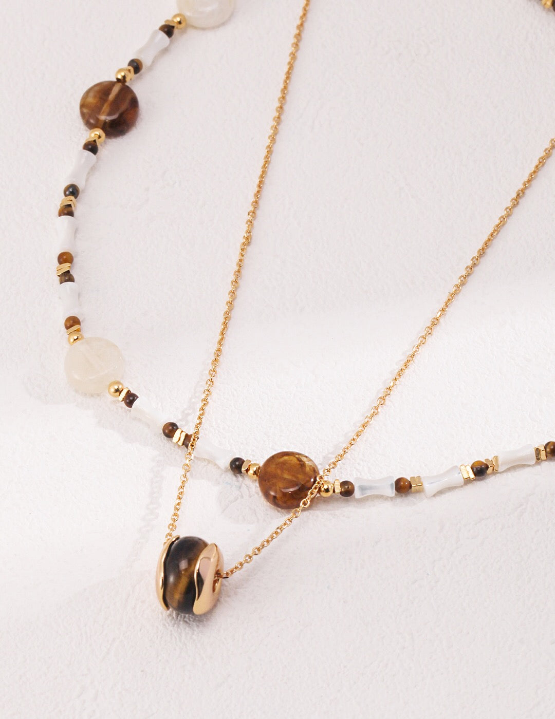 A beautiful handmade Tiger Eye Stone Necklace featuring a heart pendant, gold vermeil accents, and a delicate chain.