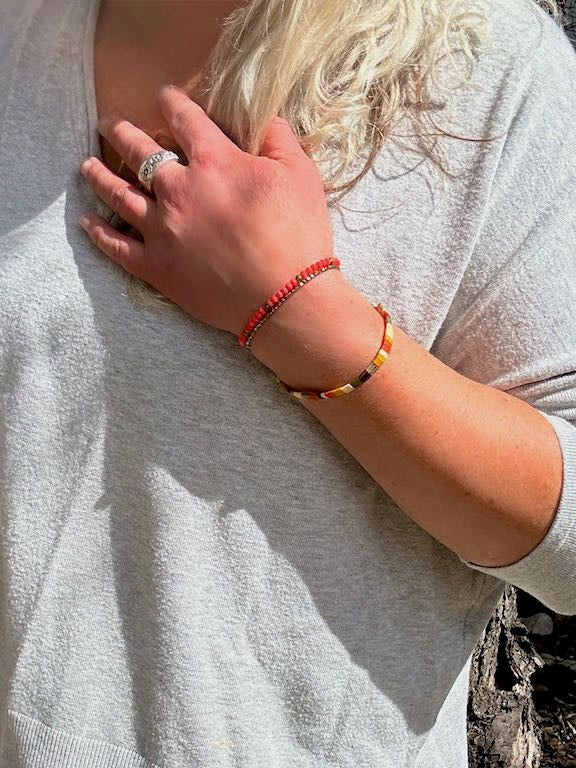 Tila Set Harvest Wheat & Orange Stretchy Tila Bead Bracelet featuring vibrant peachy-orange and wheat colors, wrapped around a wrist.