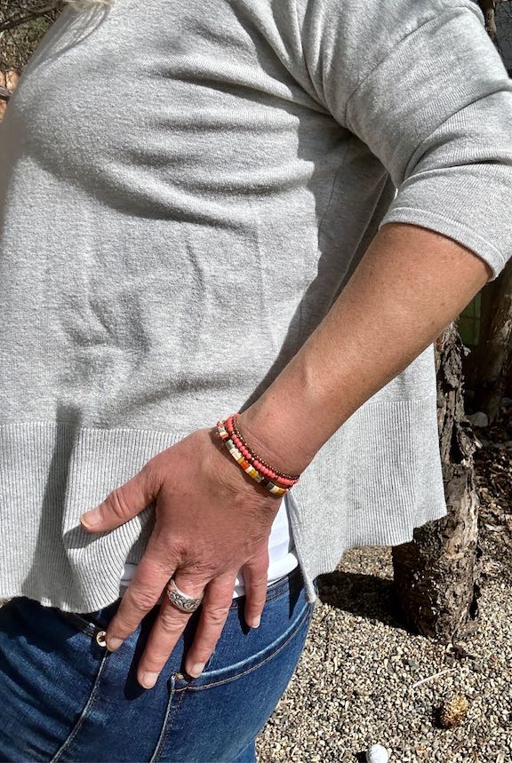 Tila Set Harvest Wheat & Orange Stretchy Tila Bead Bracelet featuring vibrant peachy-orange and wheat colors, wrapped around a wrist.