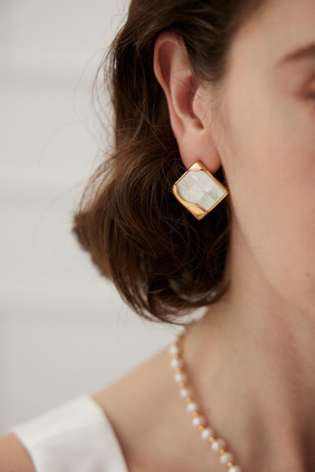 Timeless Mosaic Pure Silver Shell Earrings featuring intricate shell inlays and vintage gold finish, elegantly designed for modern and classic styles.