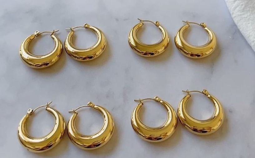 Timothy Gold Hoops earrings in small and large sizes, showcasing a thick chunky design with a polished finish.