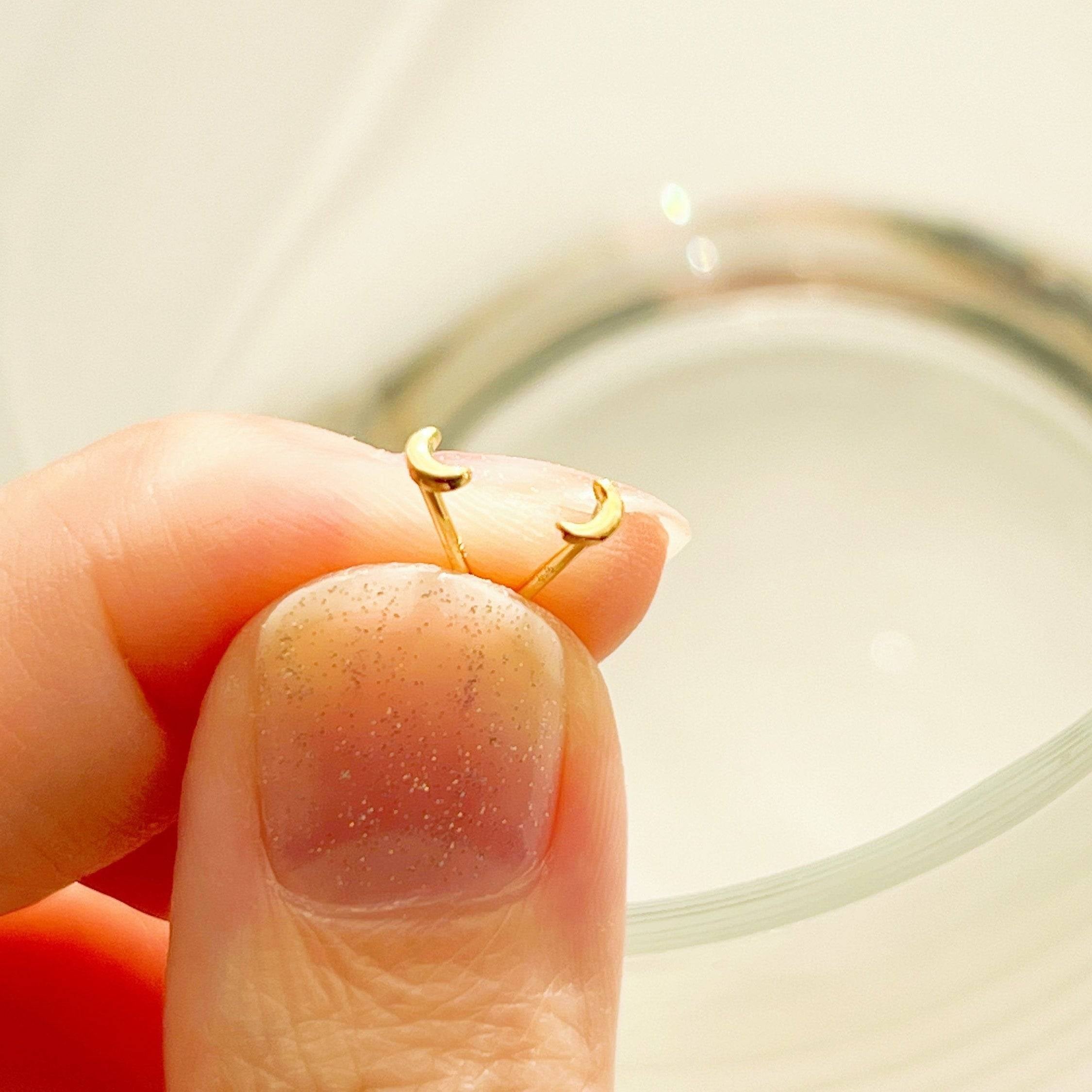 Tiny and Mini New Moon Earrings in sterling silver, showcasing a delicate moon design.