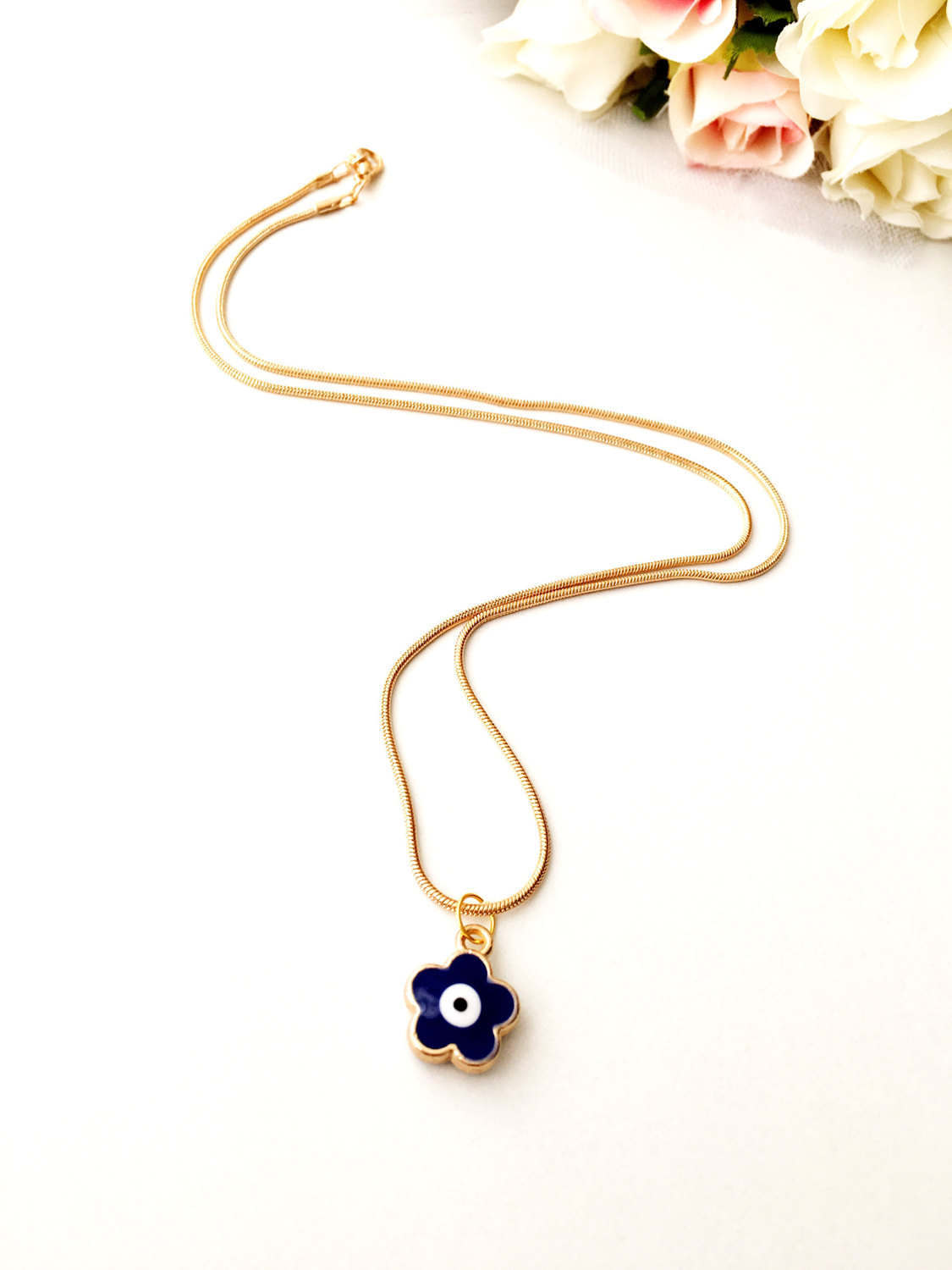 Tiny Brass Evil Eye Necklace featuring a four-leaf clover charm, handcrafted with turquoise and gold plating, perfect lucky charm for women.