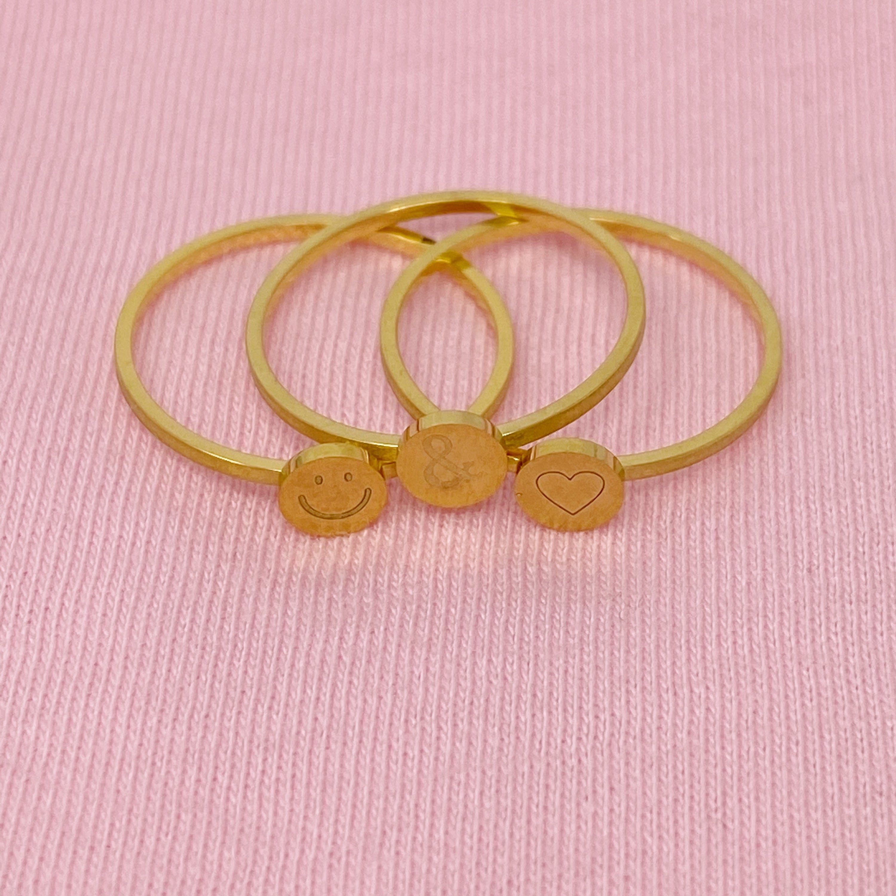 Tiny Disc Stackable Ring featuring monogrammed symbols, 18K gold plated stainless steel, size 7.