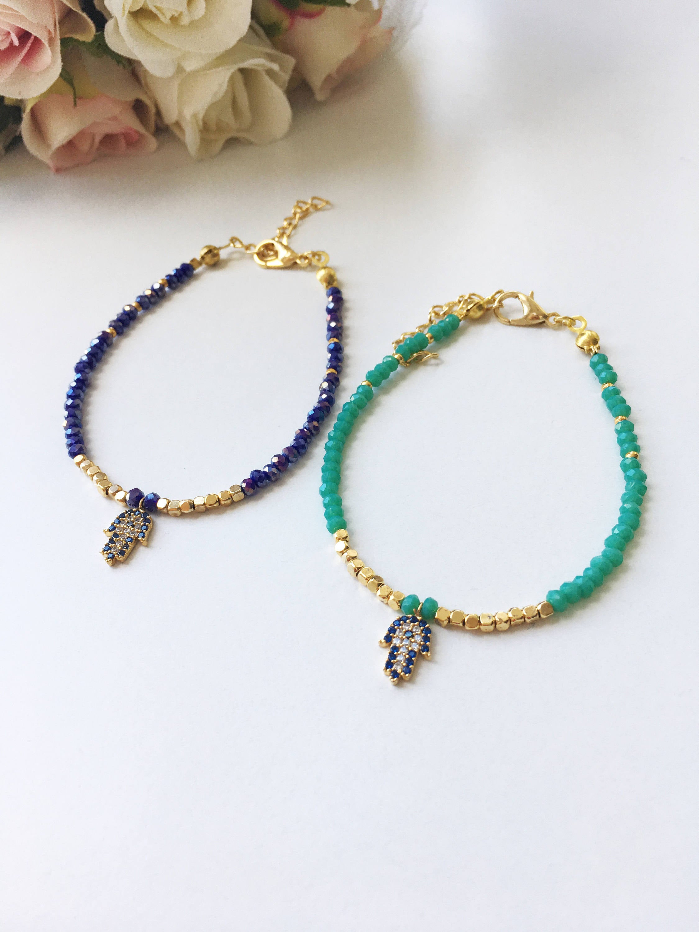 A handmade Tiny Hamsa Charm Bracelet featuring colorful Miyuki seed beads and a zirconia Hamsa charm, symbolizing protection and luck.