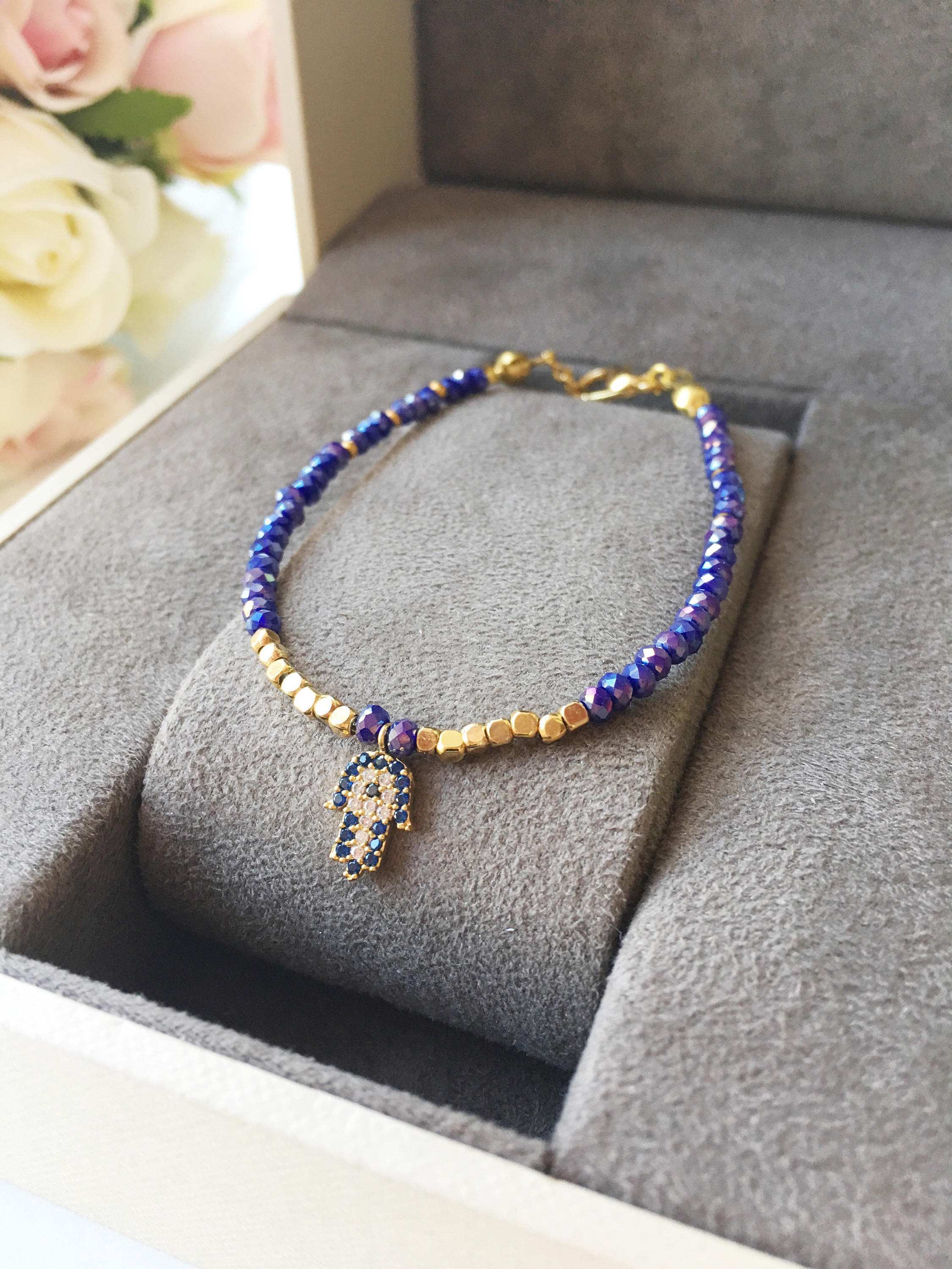 A handmade Tiny Hamsa Charm Bracelet featuring colorful Miyuki seed beads and a zirconia Hamsa charm, symbolizing protection and luck.