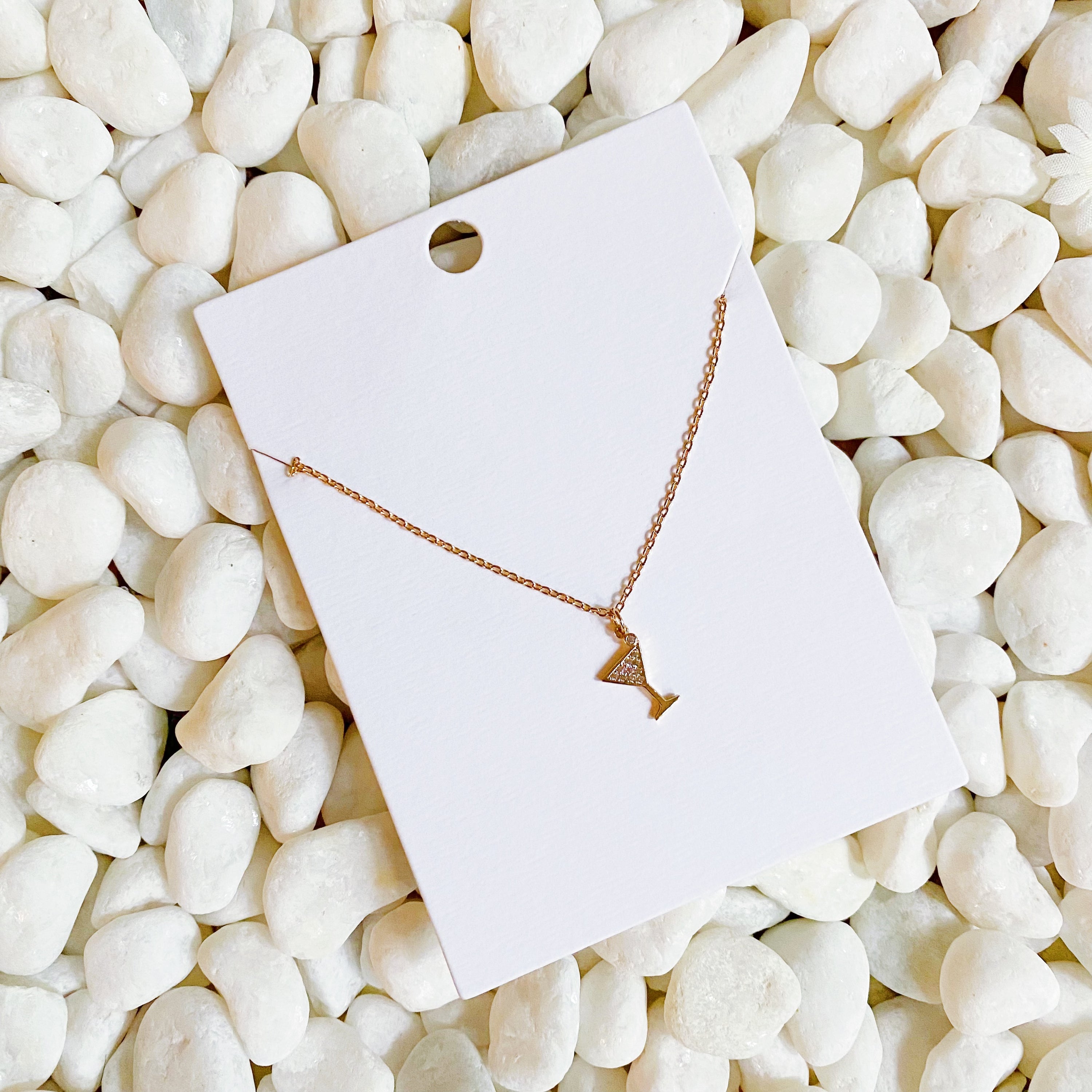 A delicate Tiny Martini Dangle Necklace featuring a gold plated brass chain and a charming martini glass pendant.