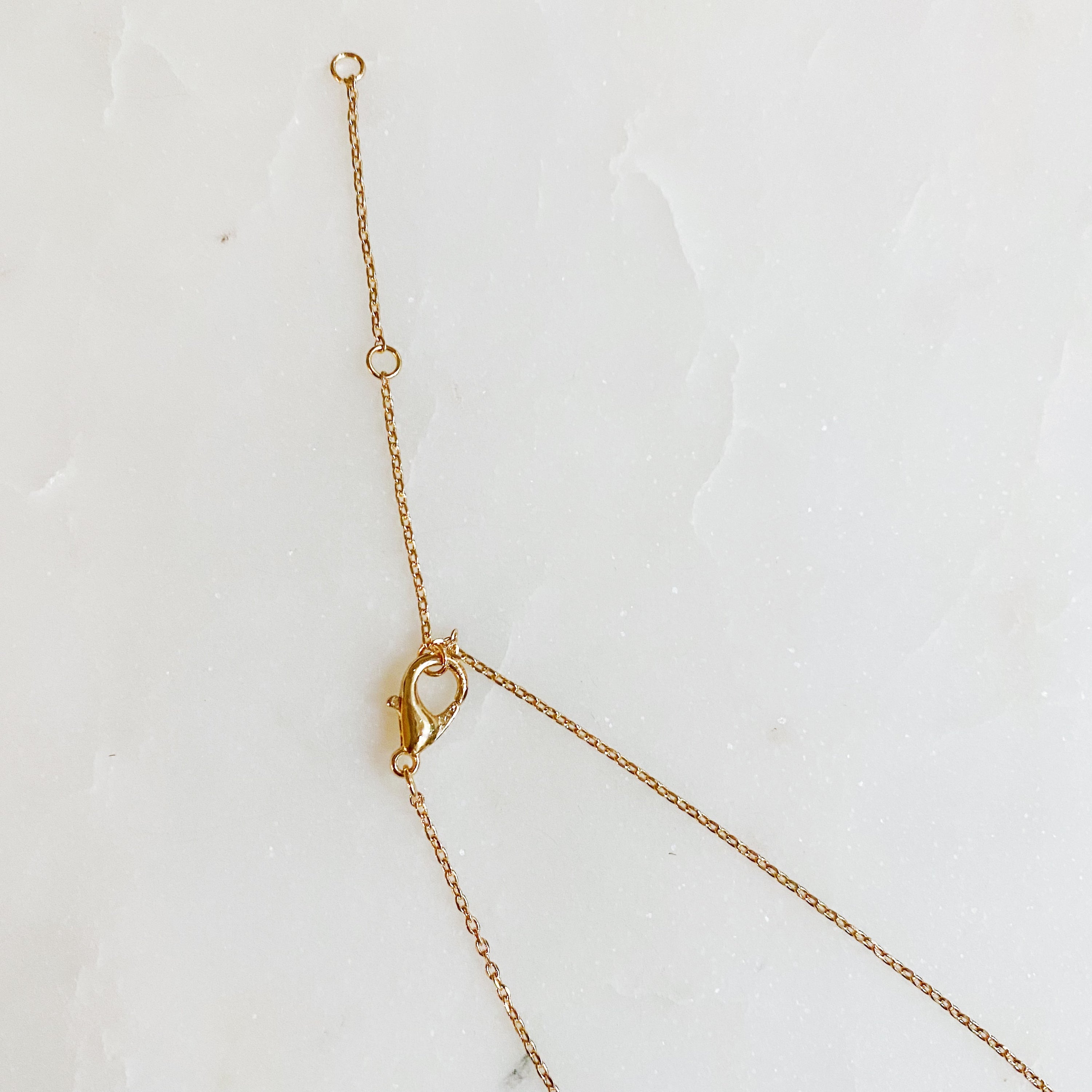 A delicate Tiny Martini Dangle Necklace featuring a gold plated brass chain and a charming martini glass pendant.