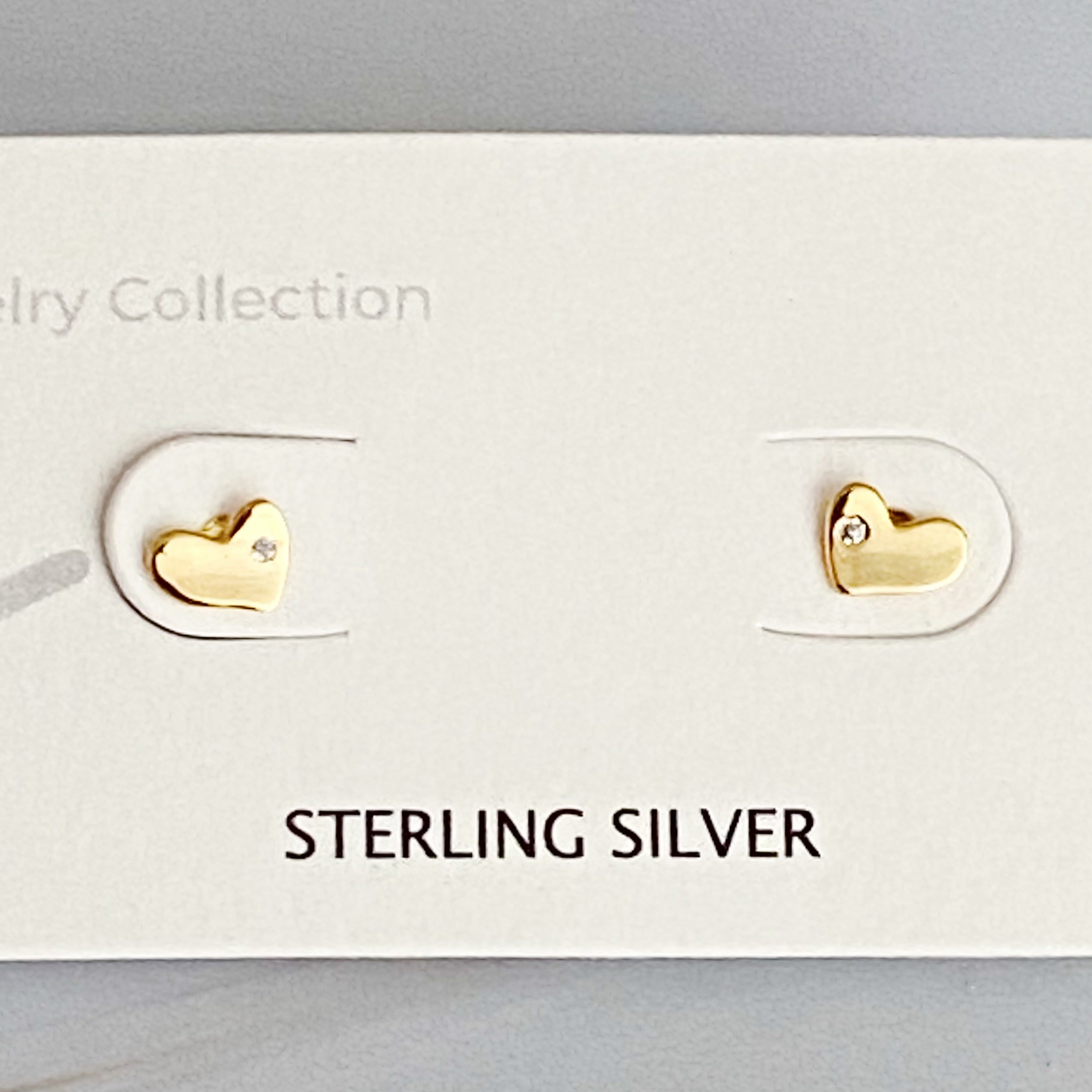 Tiny Shape Tiny Stud Sterling Silver Earrings featuring heart and flip flop designs, elegantly displayed on a logo card.