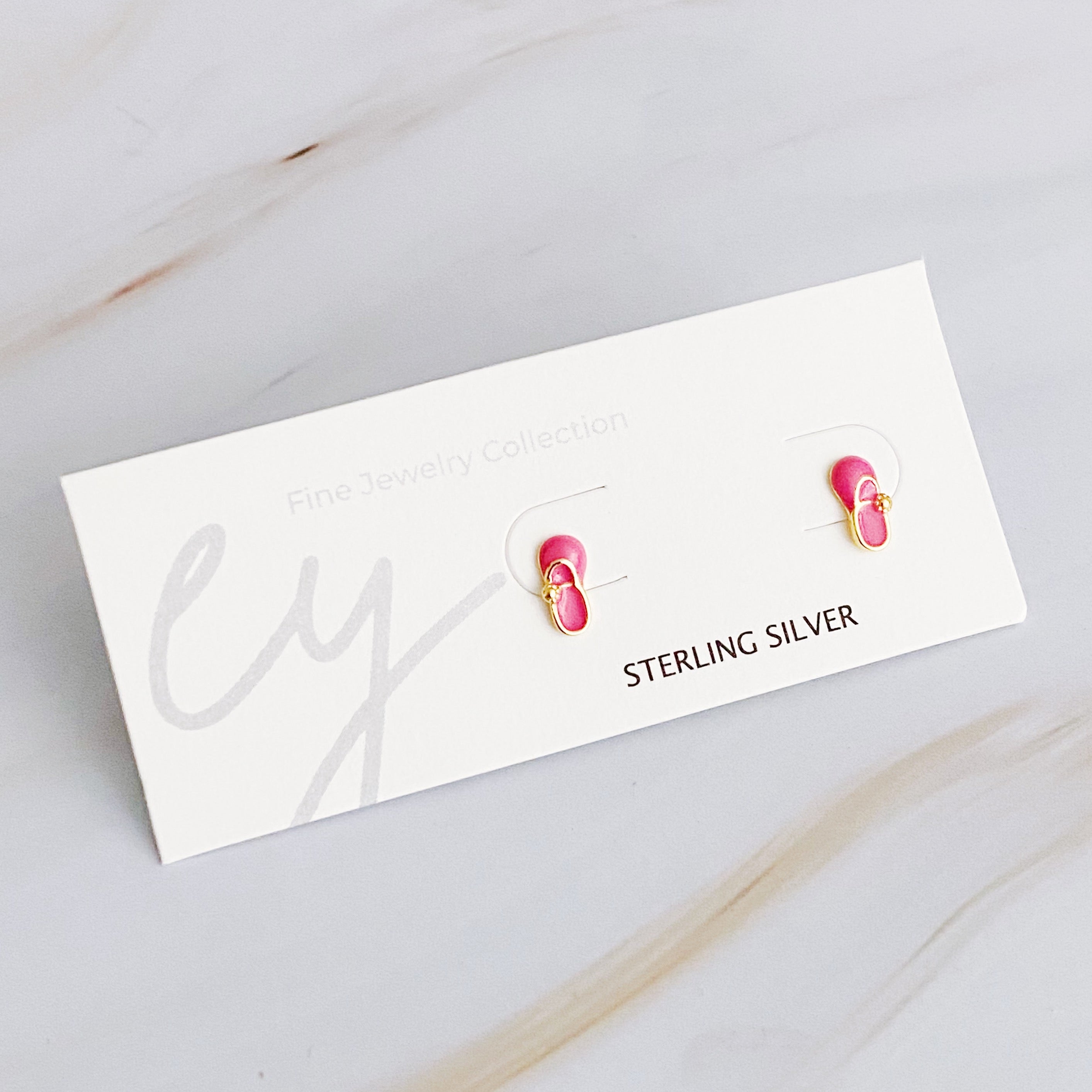 Tiny Shape Tiny Stud Sterling Silver Earrings featuring heart and flip flop designs, elegantly displayed on a logo card.