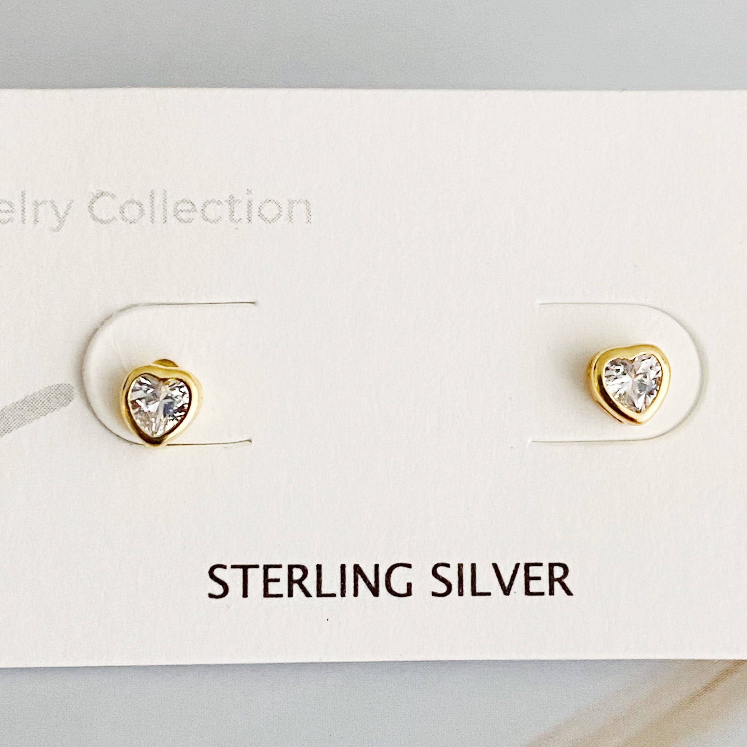 Tiny Shape Tiny Stud Sterling Silver Earrings featuring heart and flip flop designs, elegantly displayed on a logo card.