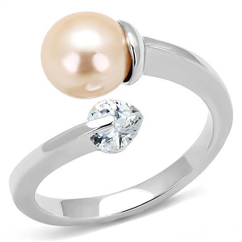 High polished stainless steel ring featuring a light peach synthetic pearl, showcasing its elegant design and shine.