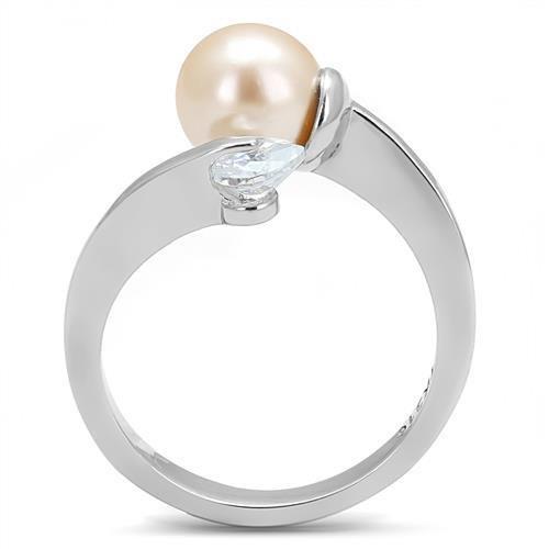 High polished stainless steel ring featuring a light peach synthetic pearl, showcasing its elegant design and shine.