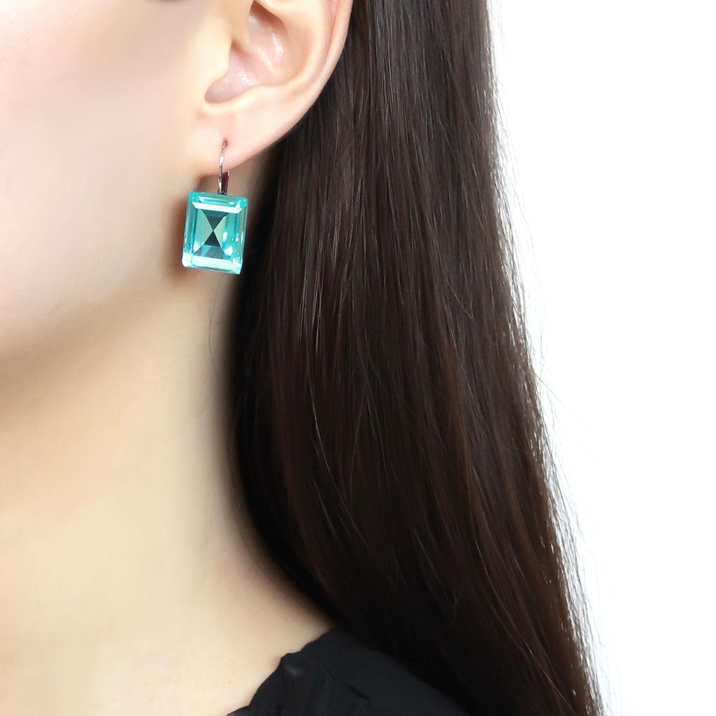 High polished stainless steel earrings featuring a sea blue top grade crystal, elegantly designed for everyday wear.