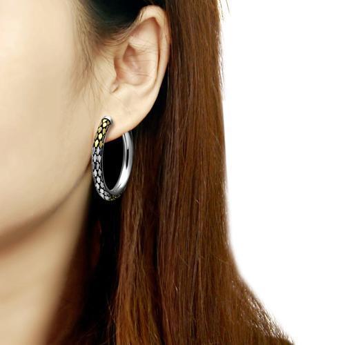 Person wearing a hoop earring.