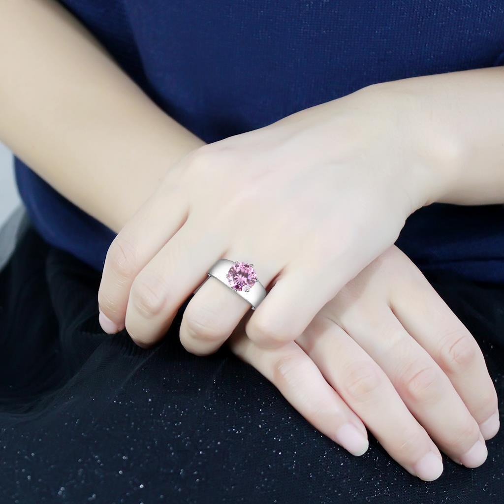 TK52010 High Polished Stainless Steel Ring featuring a rose-colored AAA Grade CZ stone, showcasing its elegant design and shine.