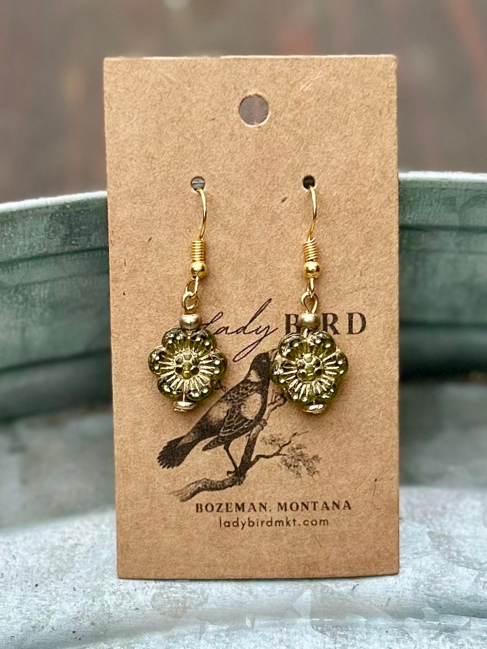 Translucent green Czech glass wild rose flower earrings with gold etching, showcasing a delicate floral design.