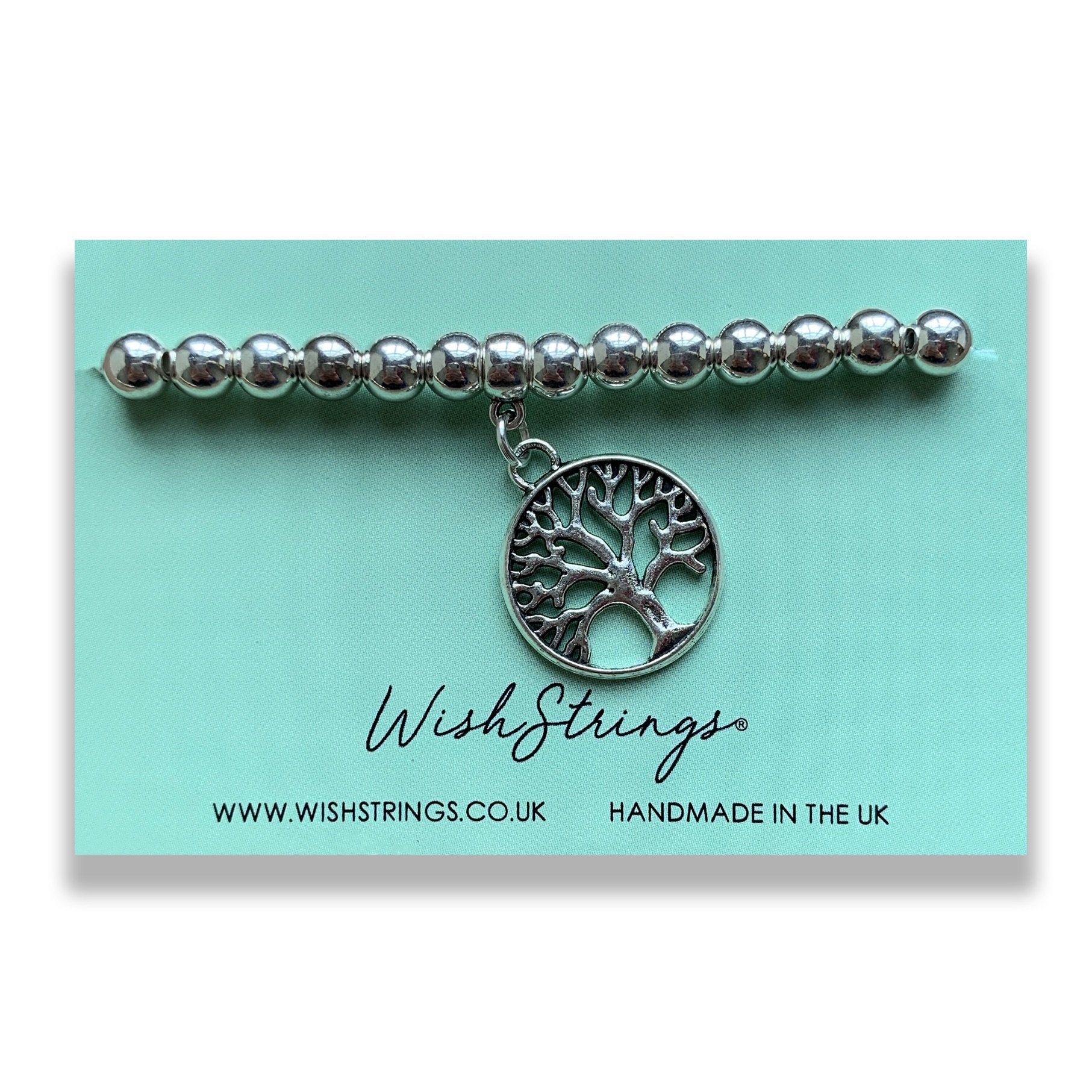 Tree of Life Charm Bracelet featuring a Tibetan charm on a stretch elastic band, beautifully presented on a gloss card.