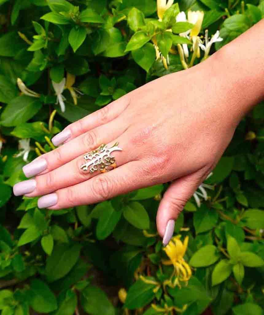 A beautifully crafted Tree of Life Ring featuring an intricate tree medallion design, made from hypoallergenic brass and silver.