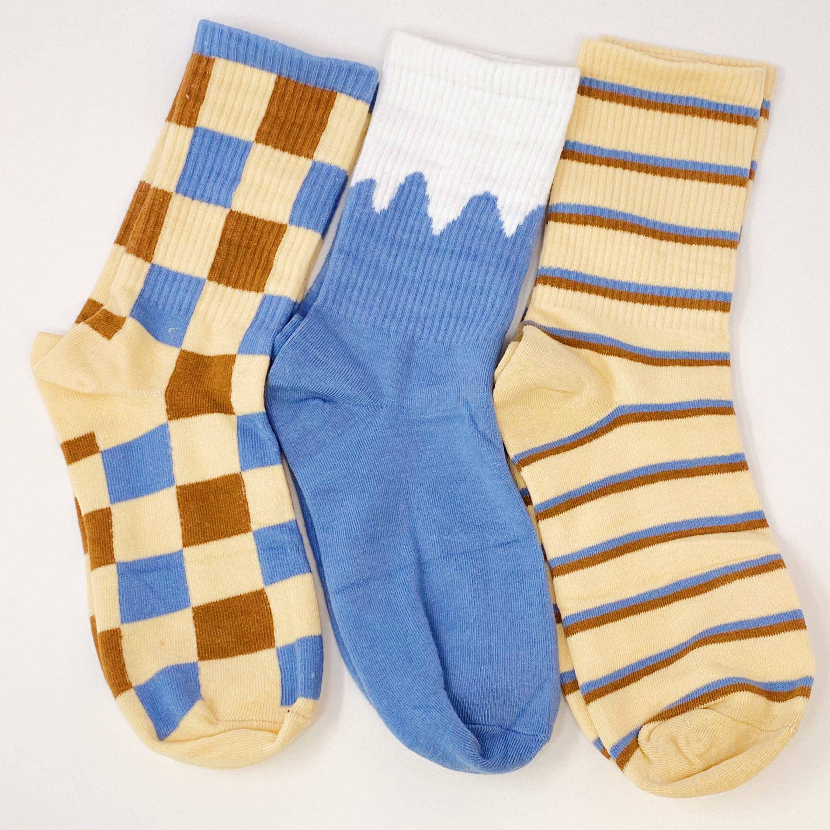 Trendy Pattern Trio Socks Set featuring three stylish pairs in unique designs, packaged in a clear cello bag.