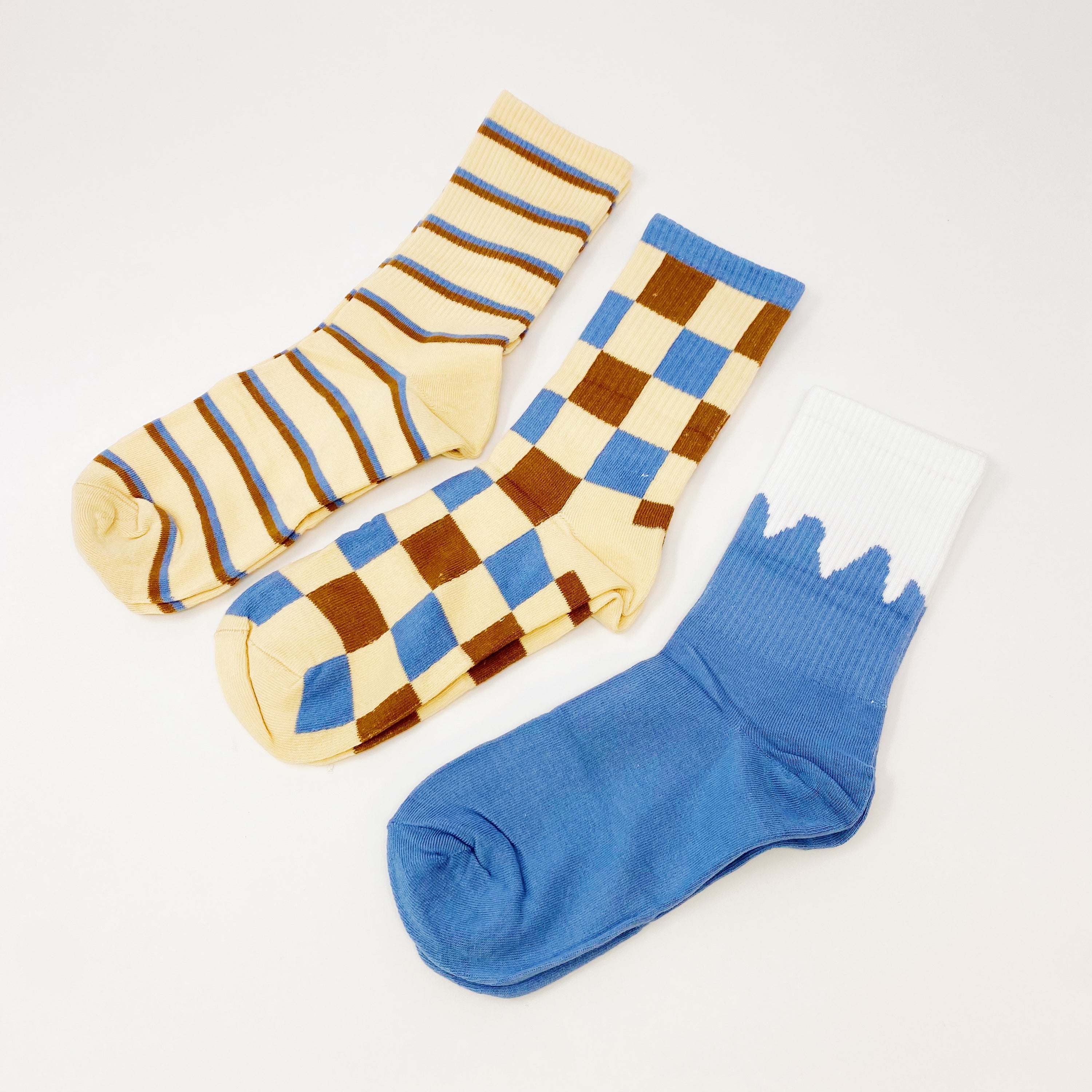 Trendy Pattern Trio Socks Set featuring three stylish pairs in unique designs, packaged in a clear cello bag.