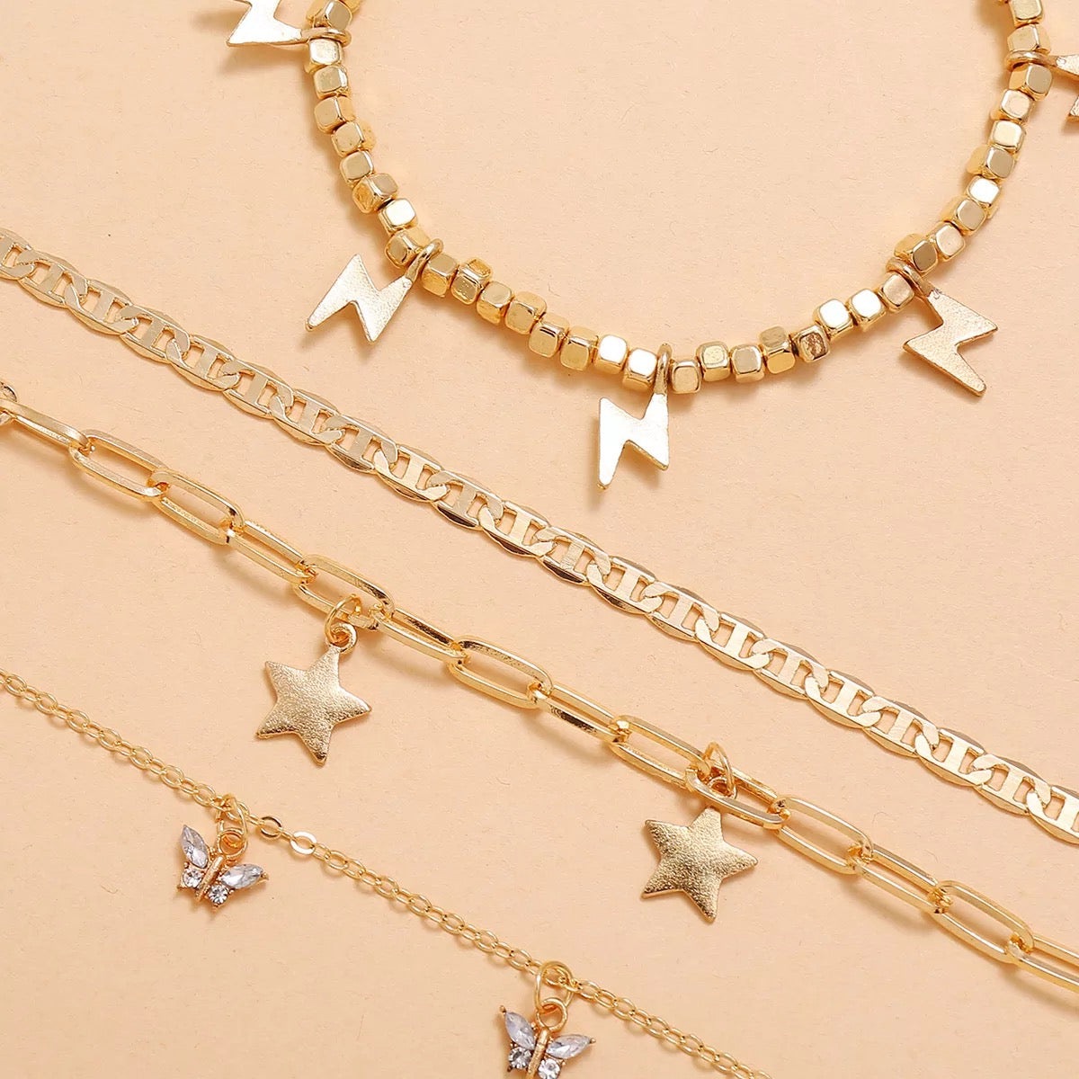 Trendy Player Anklet Set featuring four stylish gold plated anklets with adjustable sizes.