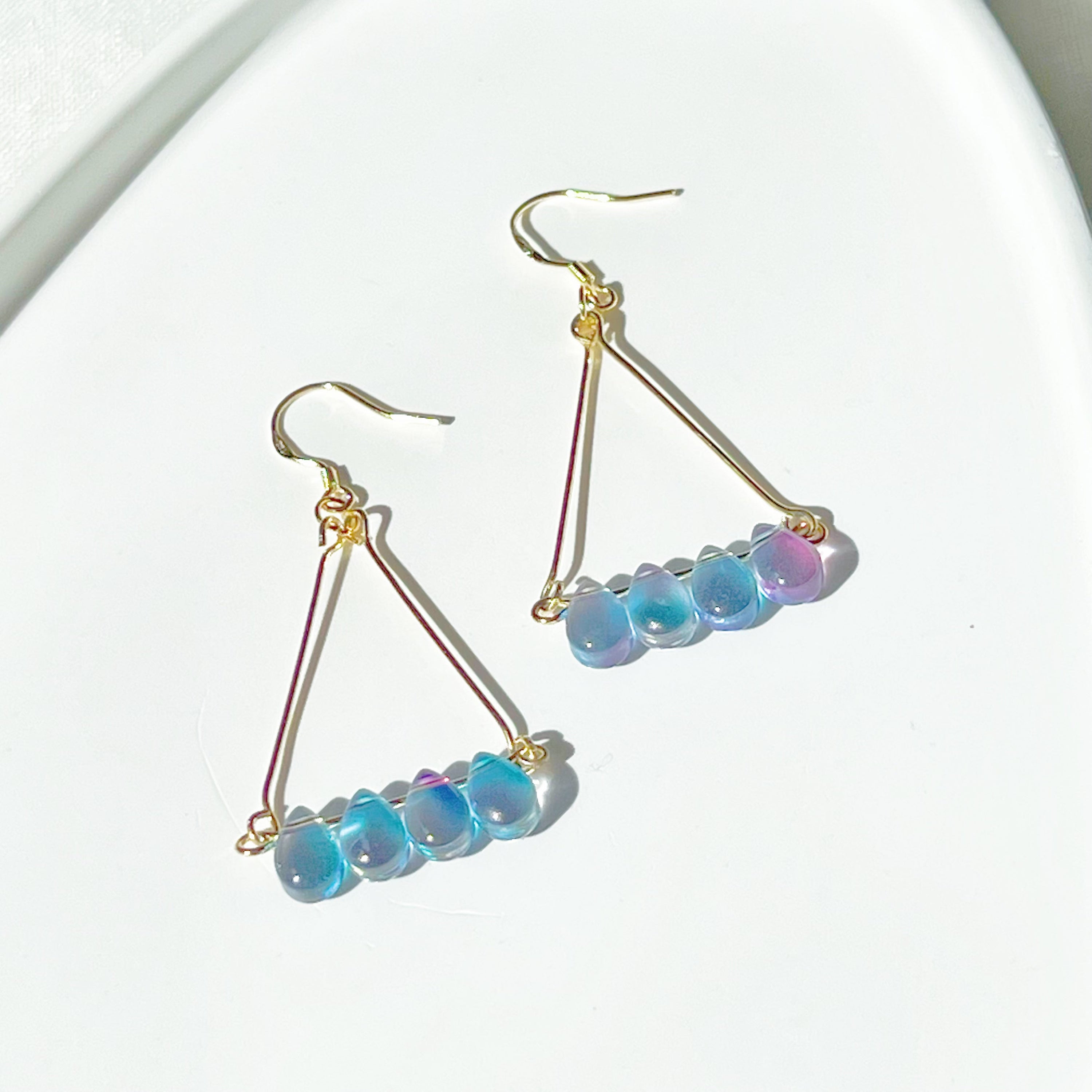 Elegant Triangle Blue Water Drop Raindrop Earrings featuring blue and purple acrylic beads with sterling silver ear wires.