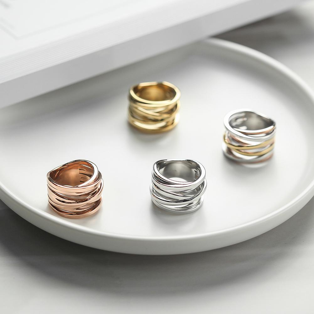 Tricolor Intertwined Statement Ring made of surgical stainless steel with 14K gold plating, showcasing its elegant design.